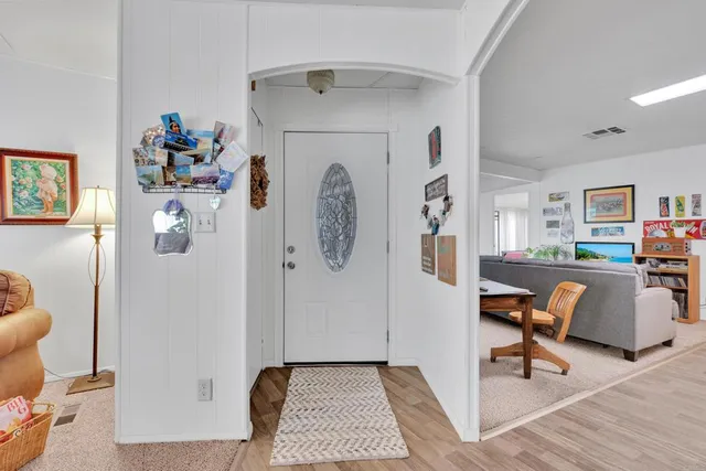 a view of a dining room with furniture and a potted plant