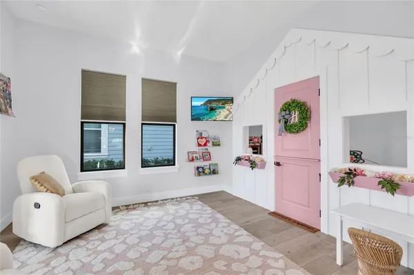 a kitchen with stainless steel appliances granite countertop a stove a sink dishwasher a dining table and chairs with wooden floor