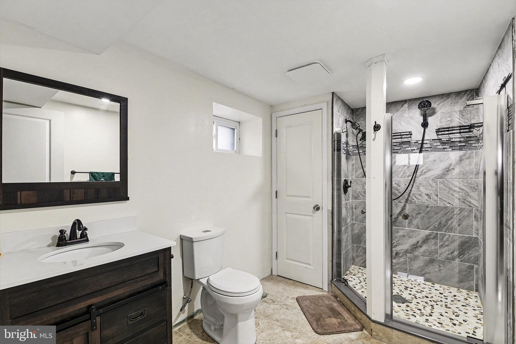 4818 Ridge Road Rosedale, MD 21237 - Photo 16 of 30 a bathroom with a granite countertop sink toilet and shower