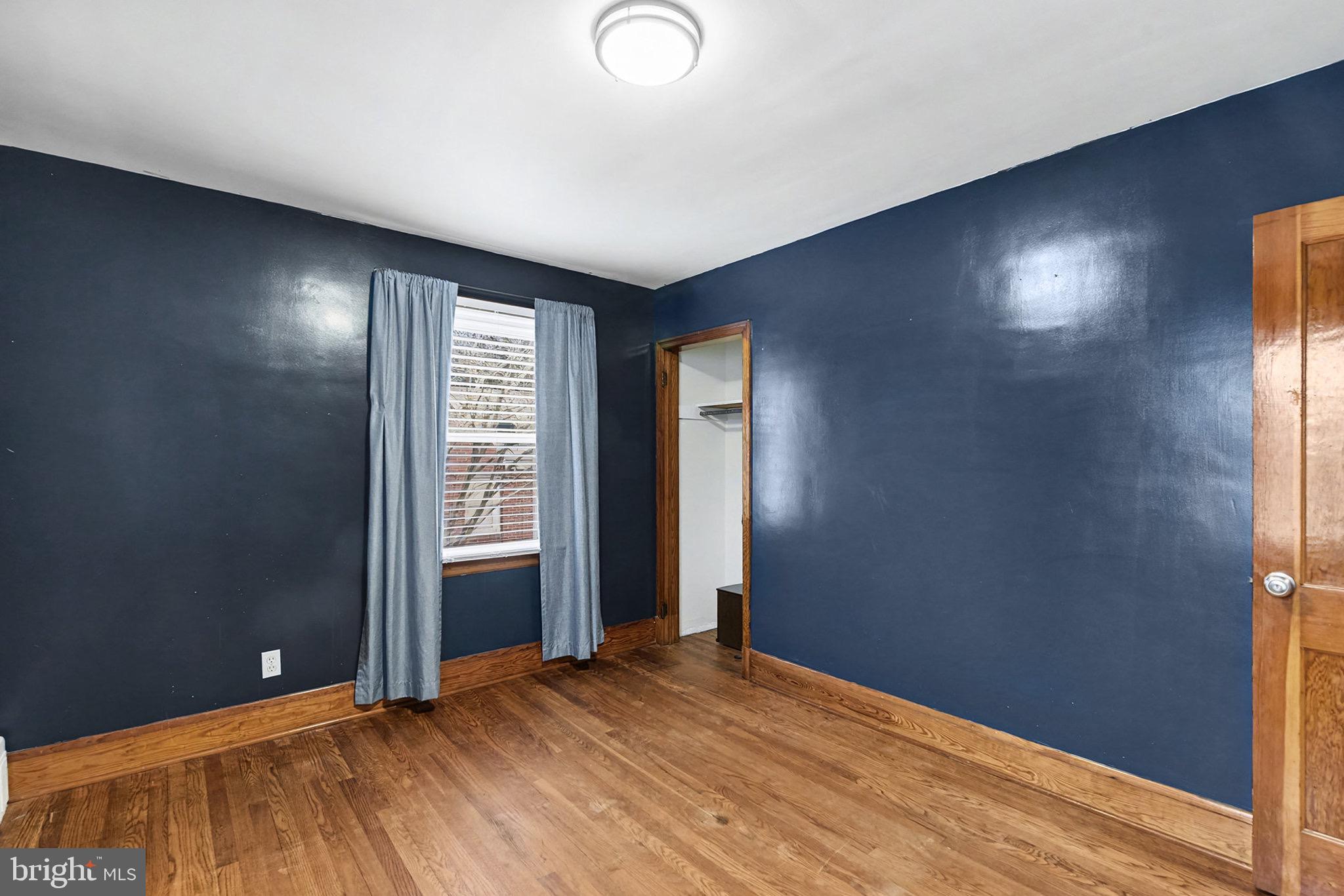 4818 Ridge Road Rosedale, MD 21237 - Photo 17 of 30 a view of an empty room with wooden floor and a window
