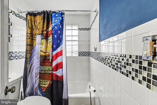 a bathroom with a sink a mirror and a shower