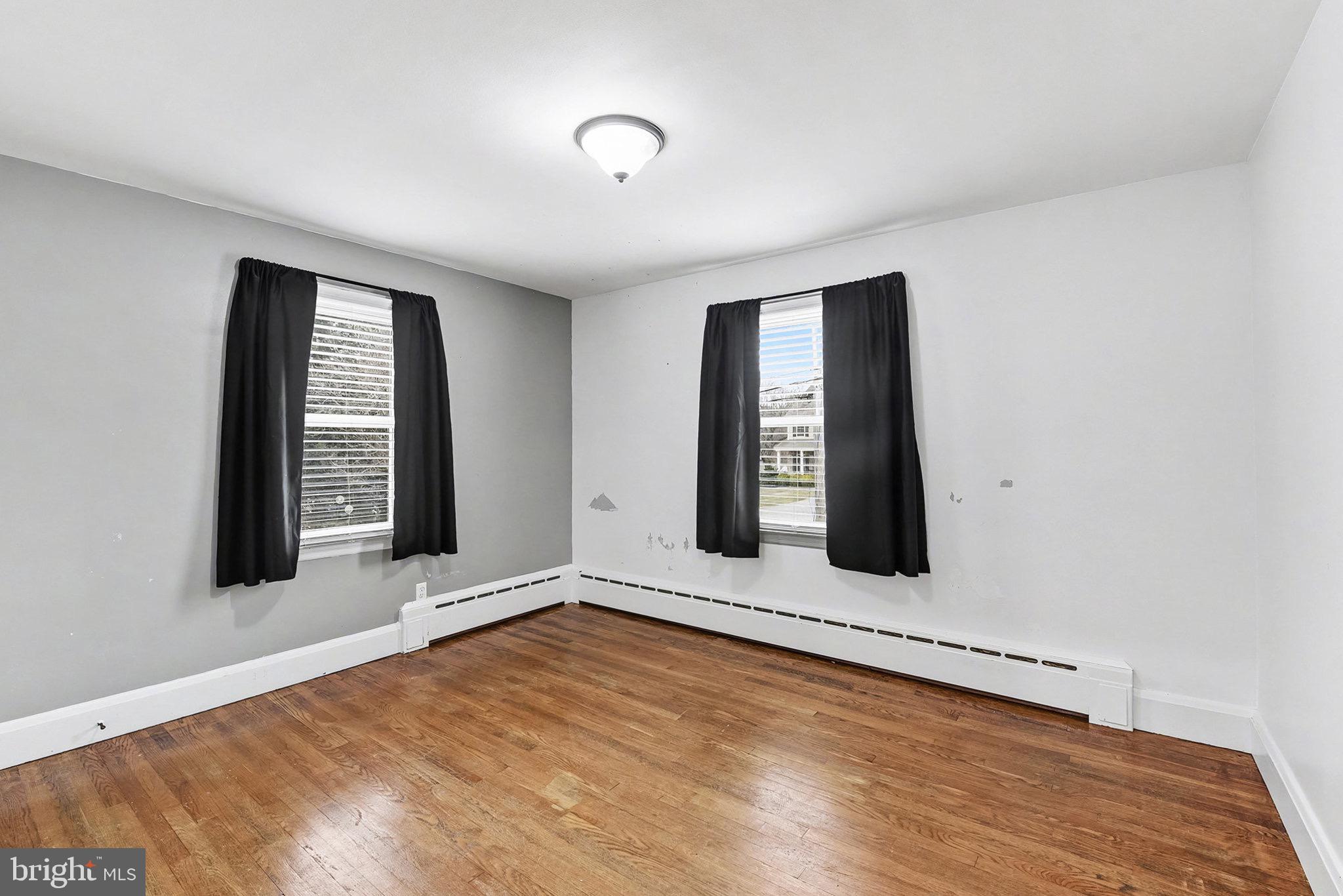 4818 Ridge Road Rosedale, MD 21237 - Photo 22 of 30 wooden floor in an empty room with a window