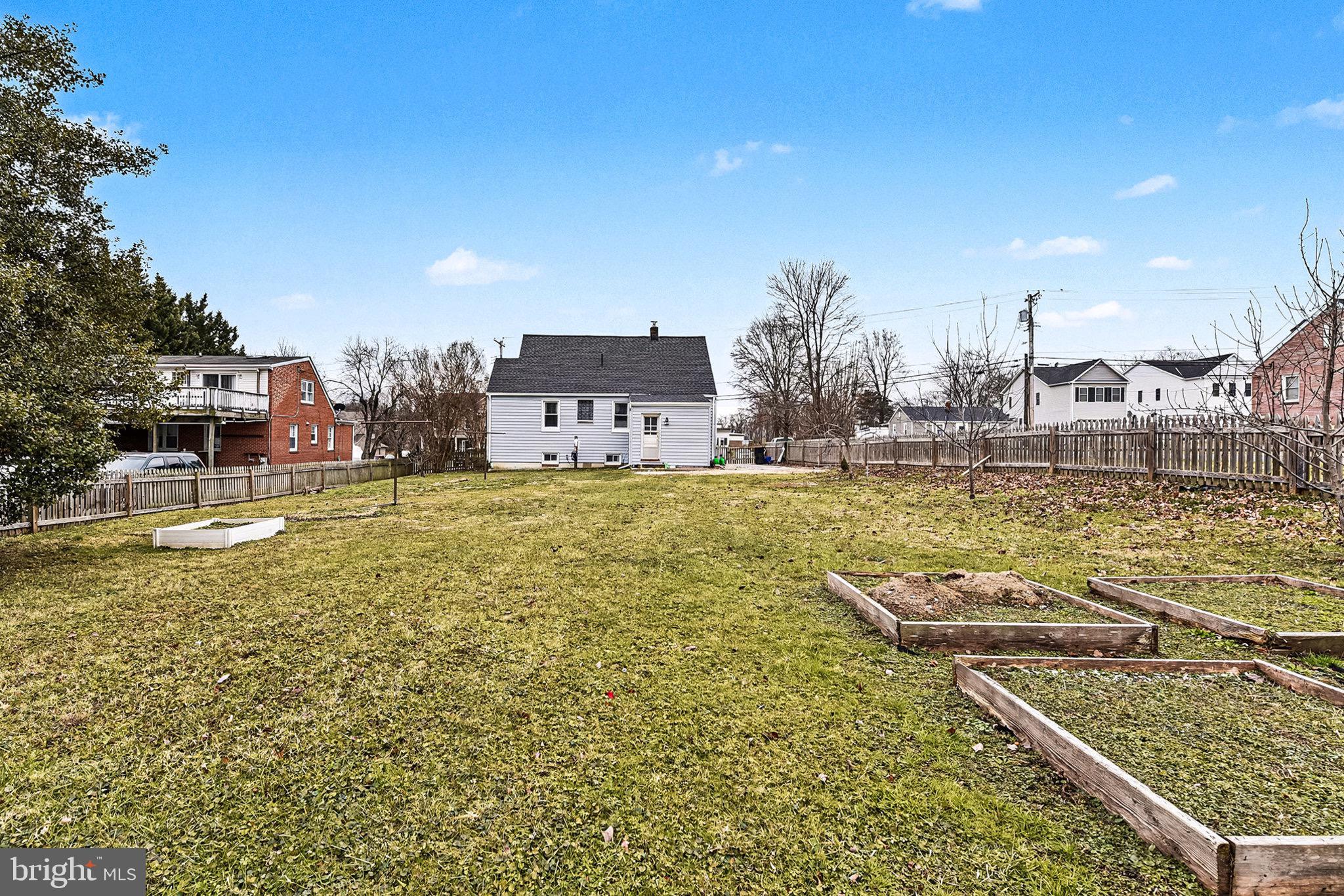 4818 Ridge Road Rosedale, MD 21237 - Photo 27 of 30 a swimming pool that has lawn chairs and a dining table under an umbrella