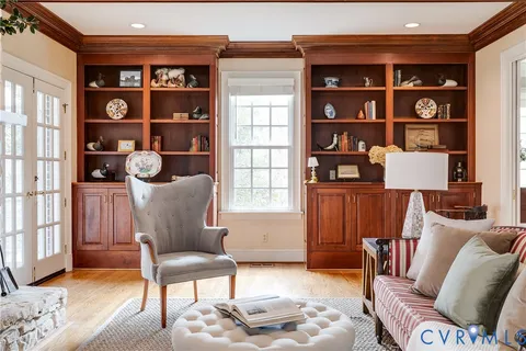 a dining table with chairs and view of living room