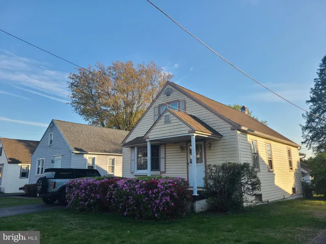 a front view of a house with a garden and plants