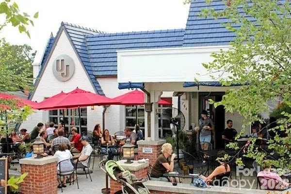 a group of people sitting outside of a restaurant