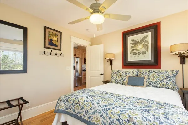 a bedroom with a large bed and a chandelier