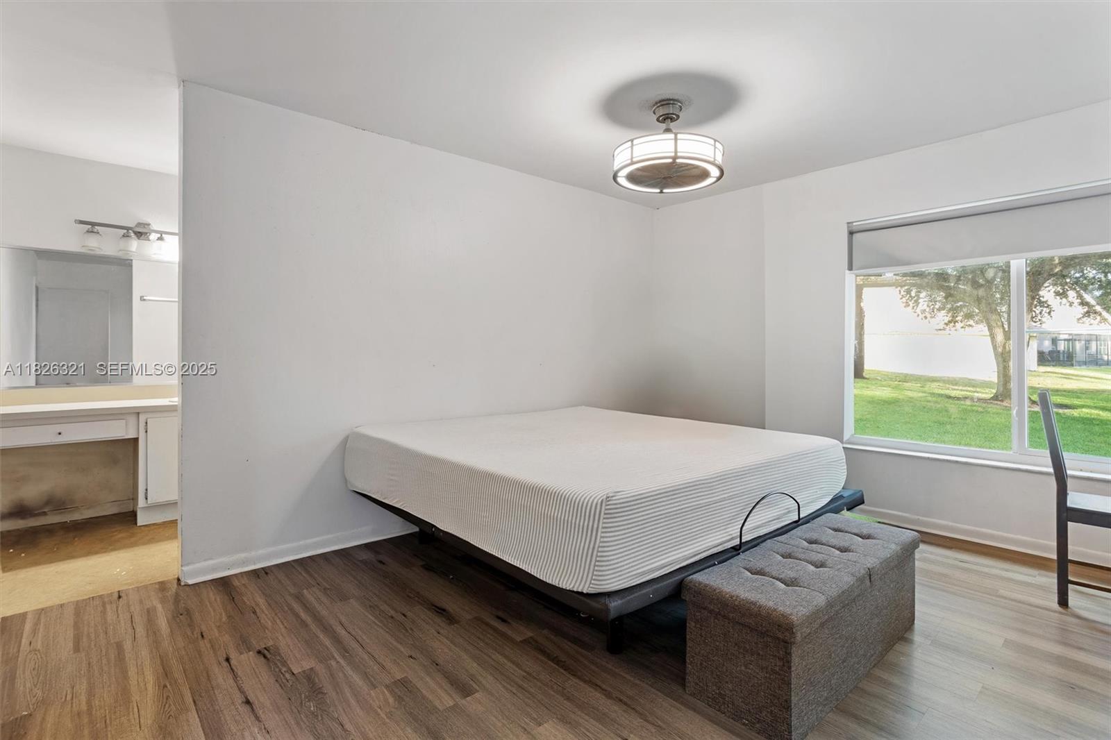 50 Forest Circle Cooper City, FL 33026 - Photo 11 of 22 a bedroom with a bed and a chandelier