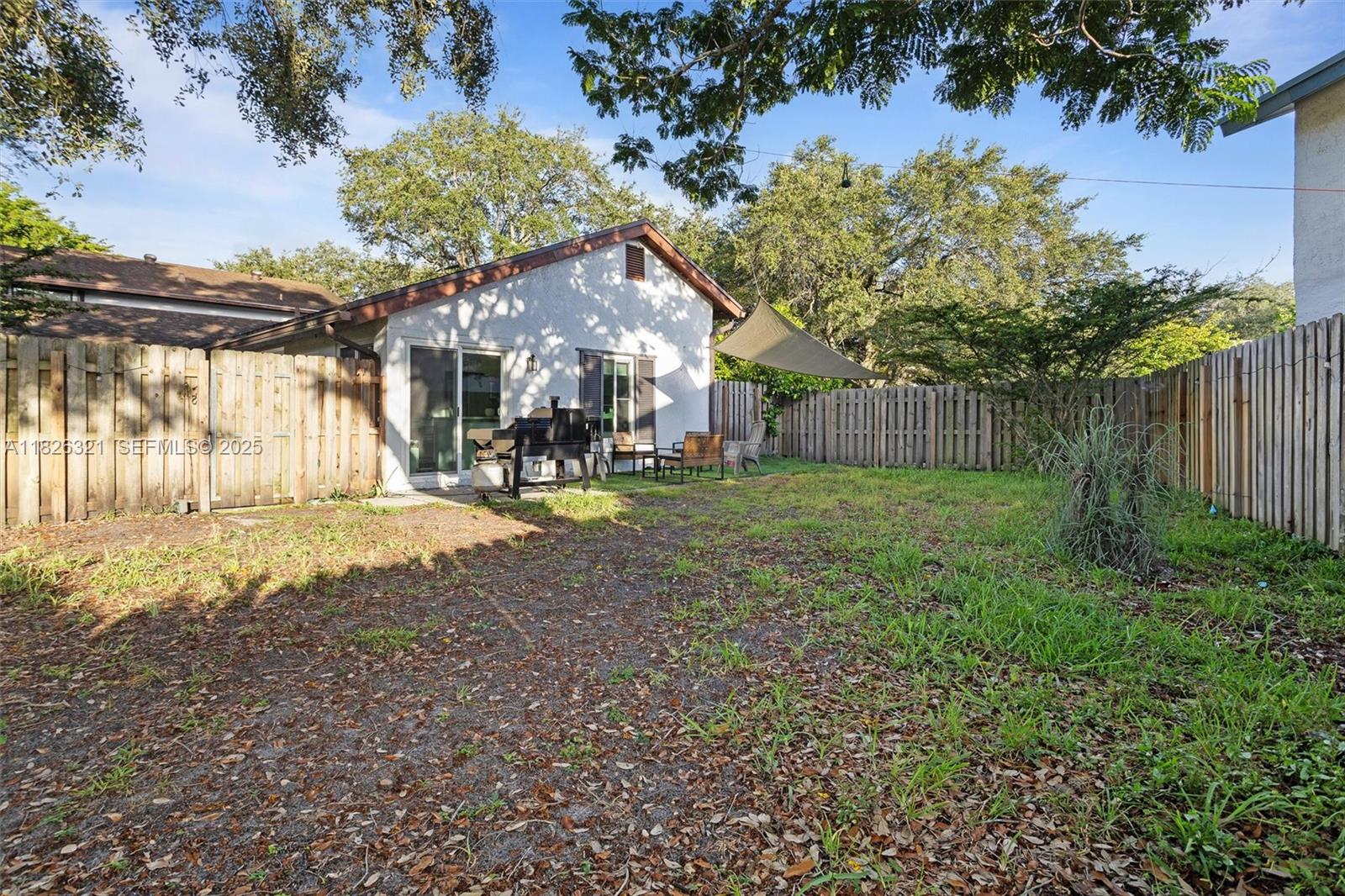50 Forest Circle Cooper City, FL 33026 - Photo 13 of 22 a view of a park that has large trees and a wooden fence