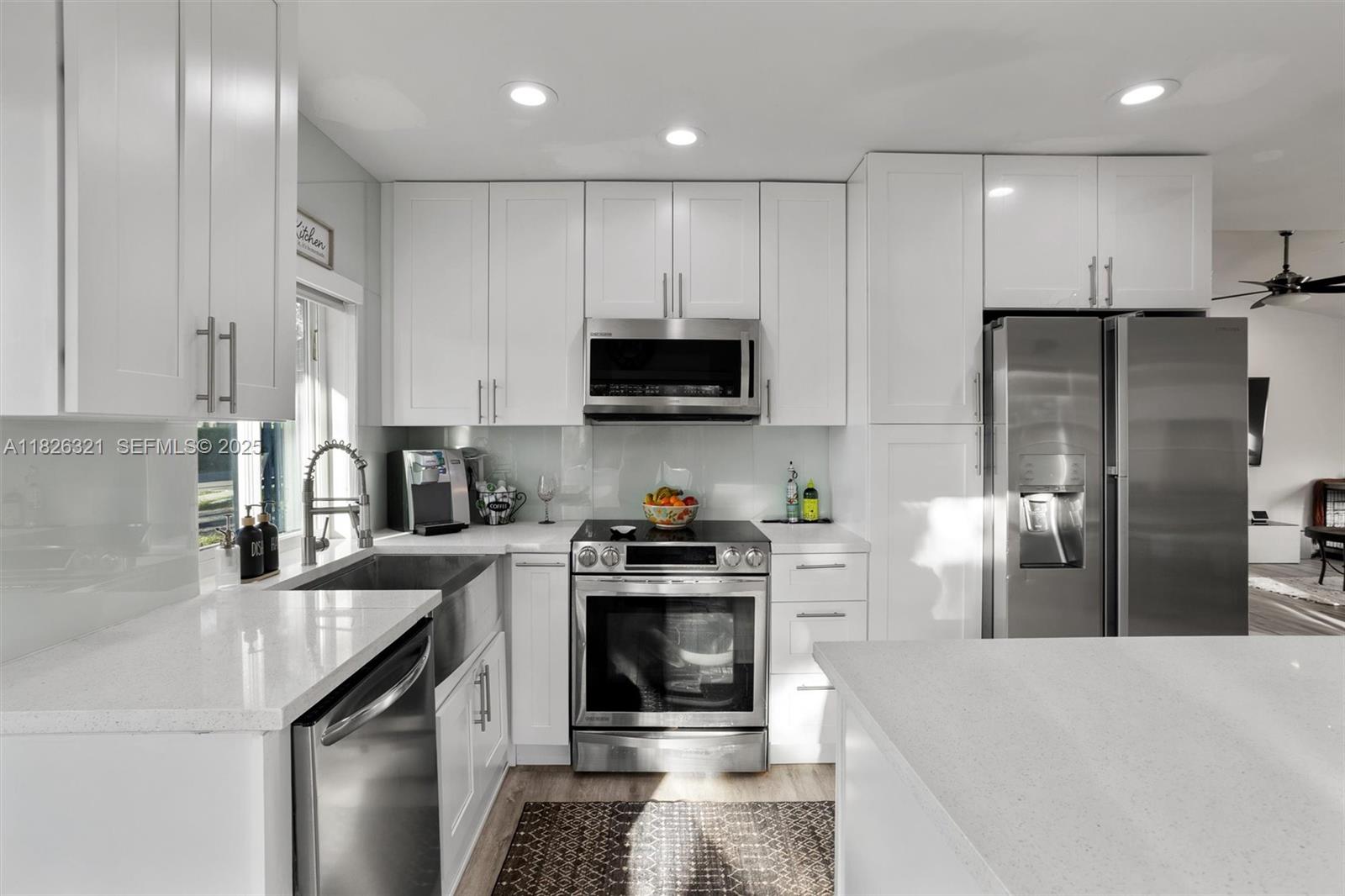 50 Forest Circle Cooper City, FL 33026 - Photo 6 of 22 a kitchen with granite countertop a refrigerator stove and sink