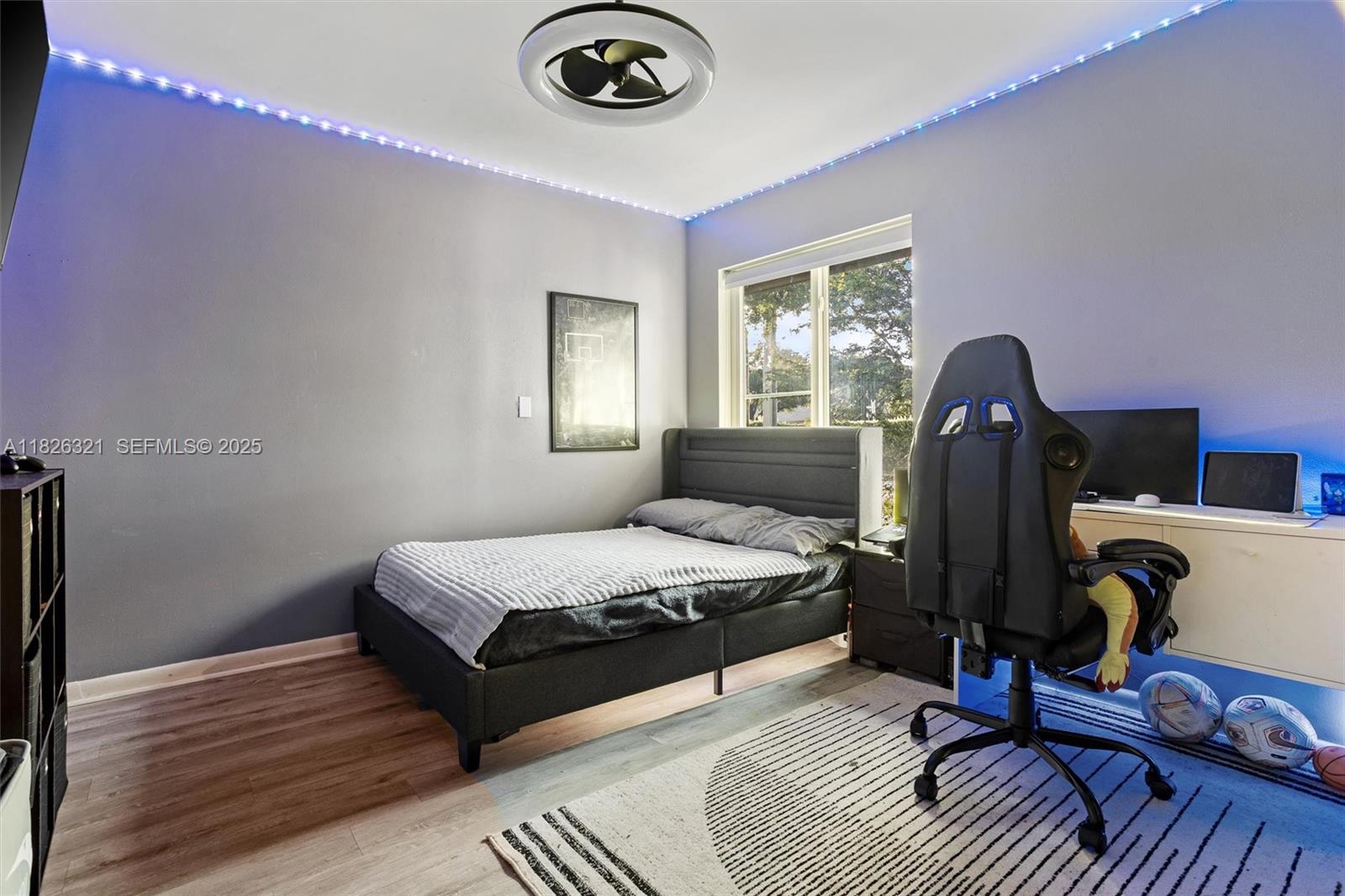 50 Forest Circle Cooper City, FL 33026 - Photo 9 of 22 a bedroom with a bed wooden floor and window