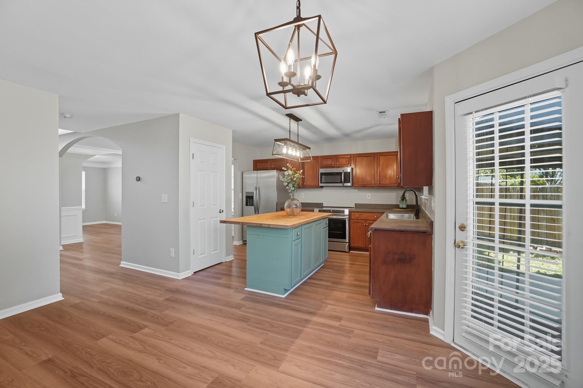 3060 Rocket Road Rock Hill, SC 29732 - Photo 12 of 31 a view of a kitchen with stainless steel appliances granite countertop a stove top oven a wooden floors