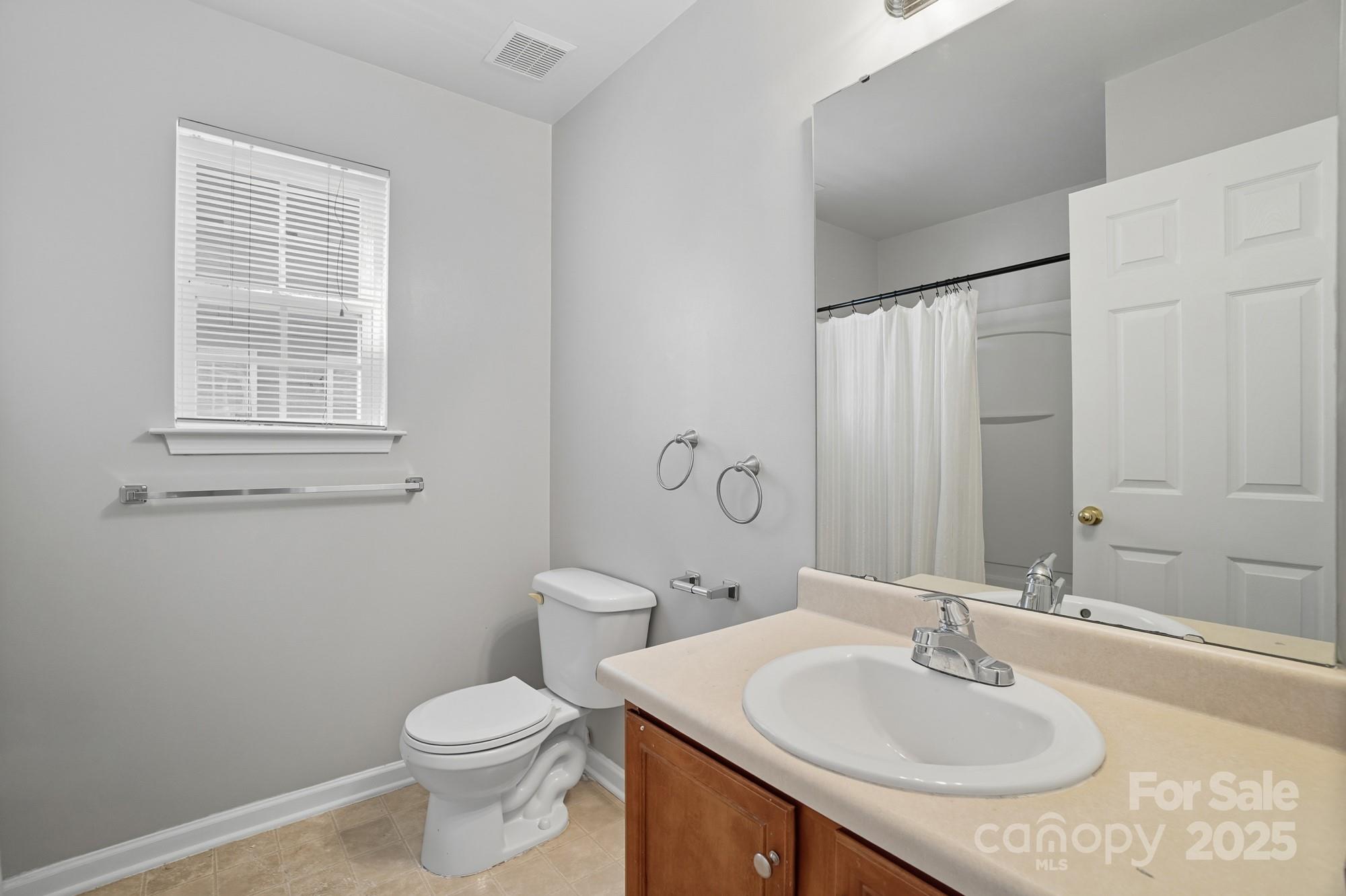 3060 Rocket Road Rock Hill, SC 29732 - Photo 27 of 31 a bathroom with a sink toilet and mirror
