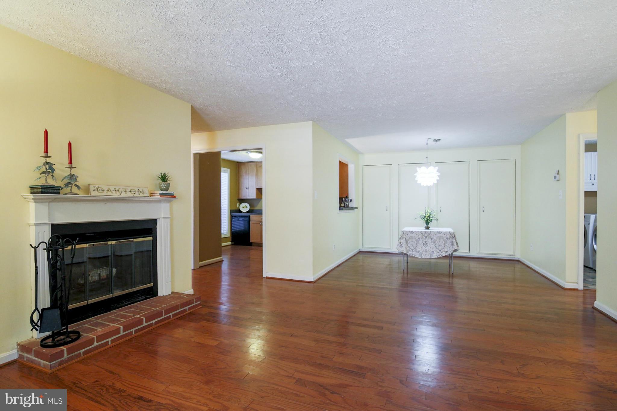 10153 Oakton Terrace Road, Unit 10153 Oakton, VA 22124 - Photo 2 of 23 Living Room has wood-burning fireplace.