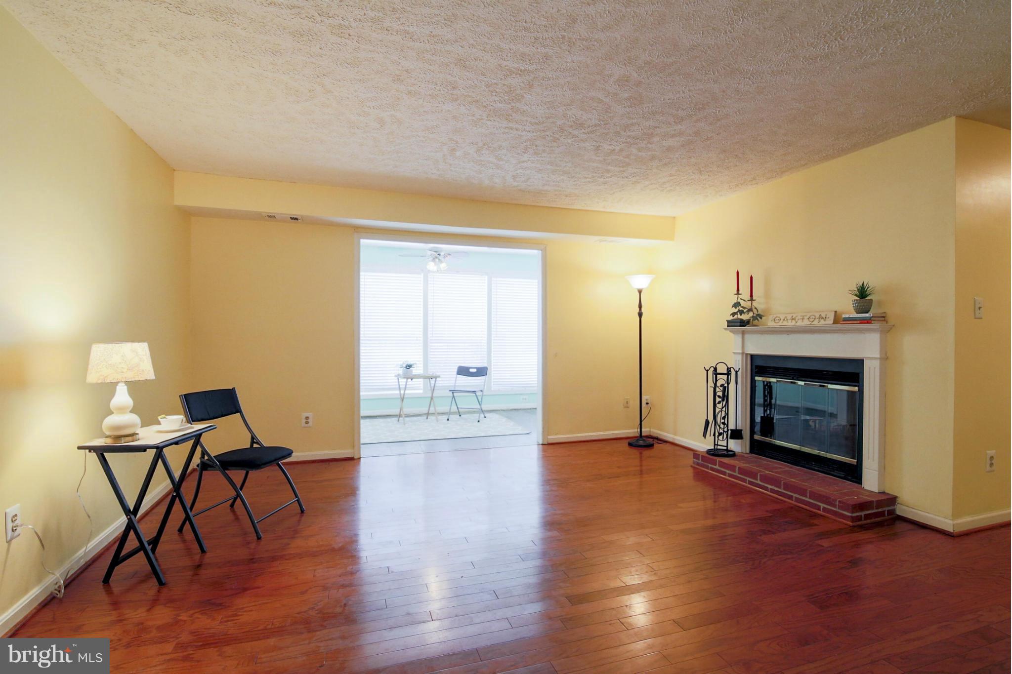 10153 Oakton Terrace Road, Unit 10153 Oakton, VA 22124 - Photo 17 of 23 Living Room bathed with natural light from sunroom