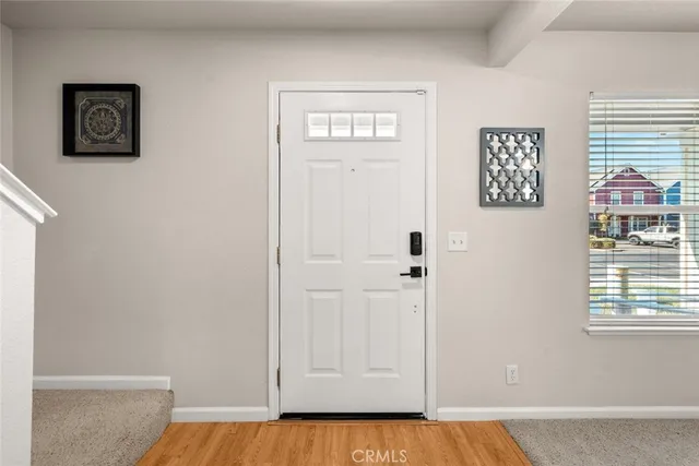 a view of an entryway with wooden floor