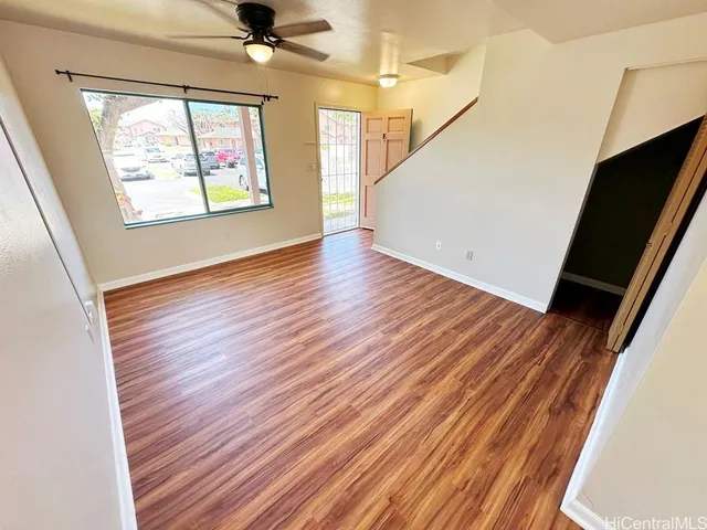 wooden floor in an empty room with a window