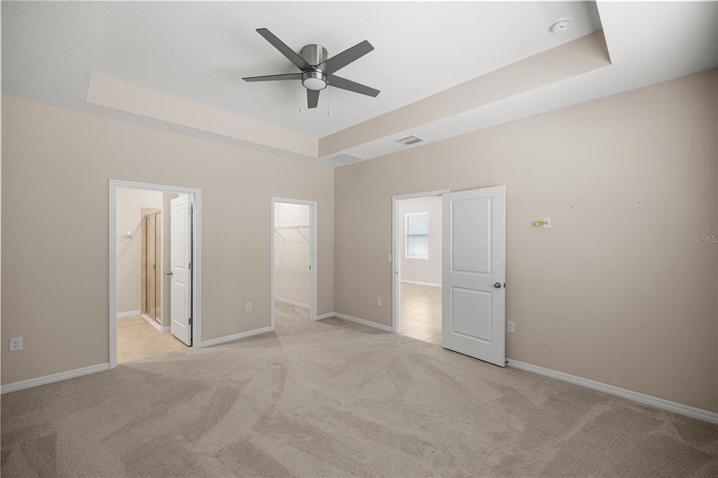 5369 Northwest 48th Lane Ocala, FL 34482 - Photo 16 of 47 an empty room with chandelier fan and windows