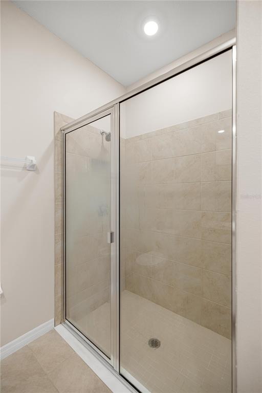5369 Northwest 48th Lane Ocala, FL 34482 - Photo 18 of 47 a bathroom with a glass shower door