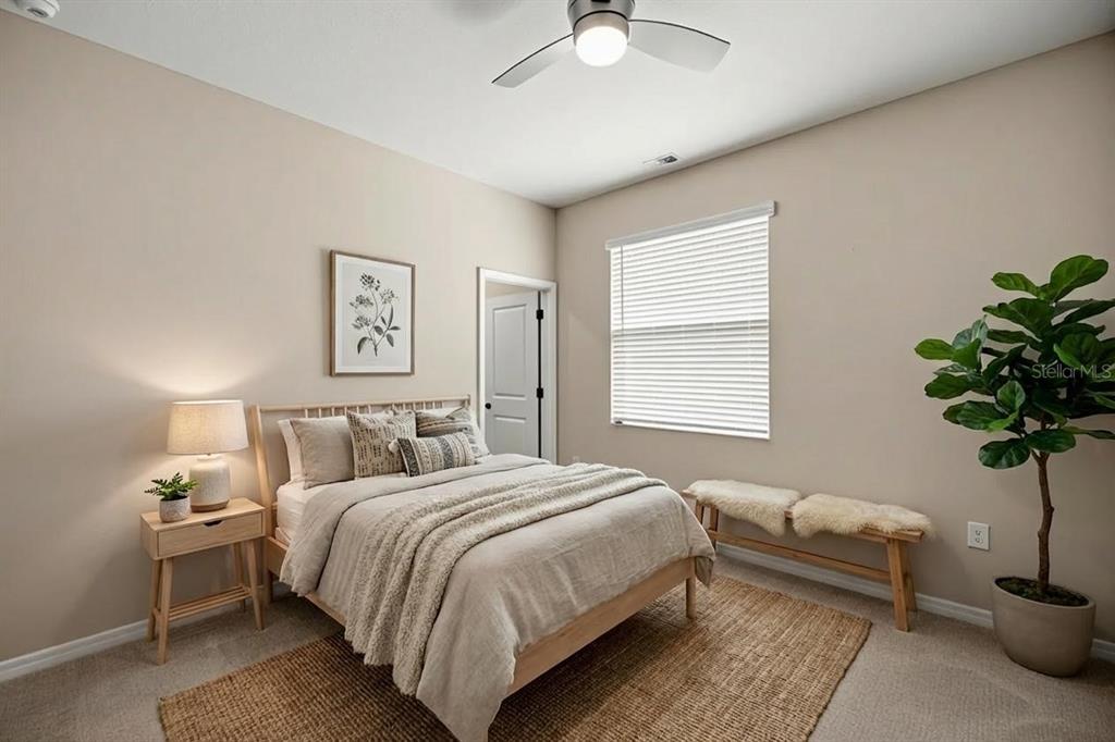 5369 Northwest 48th Lane Ocala, FL 34482 - Photo 20 of 47 a bedroom with a bed and a potted plant