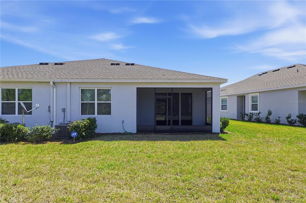 5369 Northwest 48th Lane Ocala, FL 34482 - Photo 33 of 47 a front view of a house with a garden and yard
