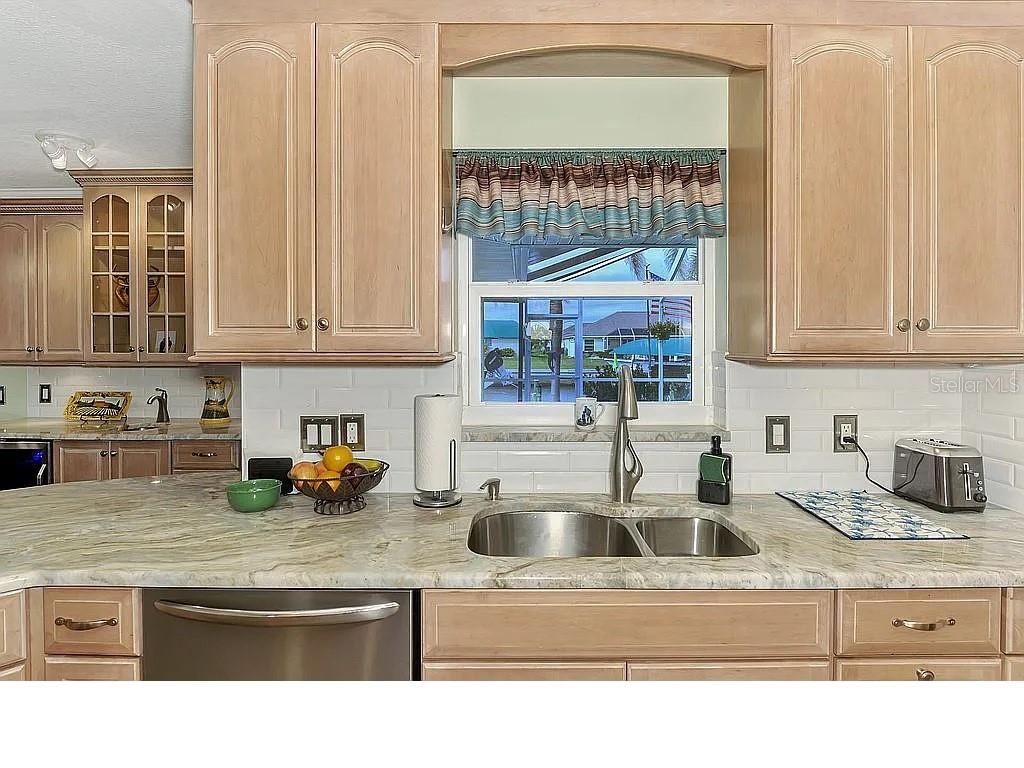5231 Conner Terrace Port Charlotte, FL 33981 - Photo 11 of 66 a kitchen with stainless steel appliances granite countertop a sink a stove and a granite counter tops