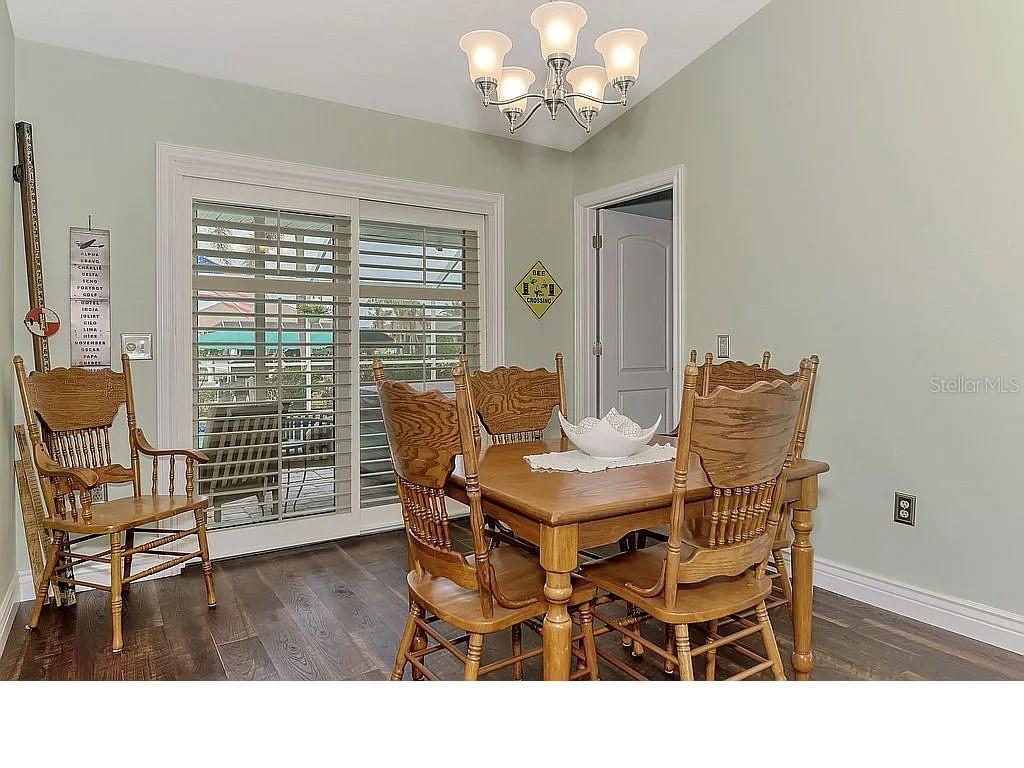 5231 Conner Terrace Port Charlotte, FL 33981 - Photo 25 of 66 a dining room with furniture a large window and wooden floor