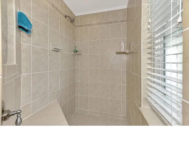 a kitchen with a refrigerator and wooden cabinets
