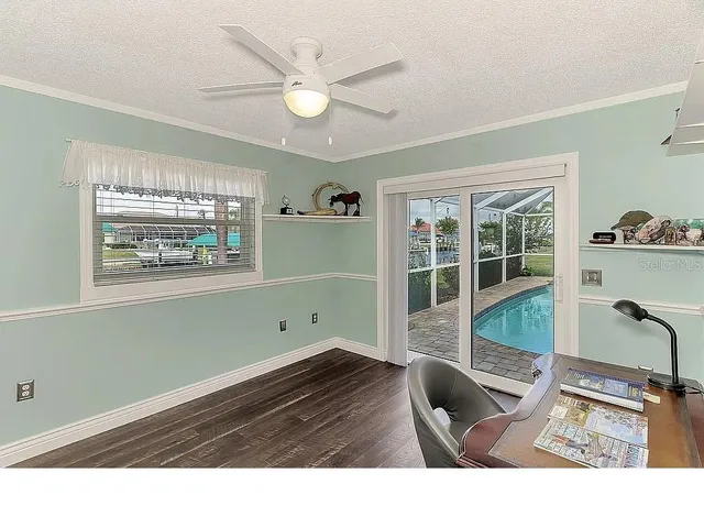 a view of swimming pool with table and chairs