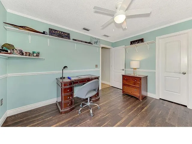 a view of a house with a swimming pool and sitting area