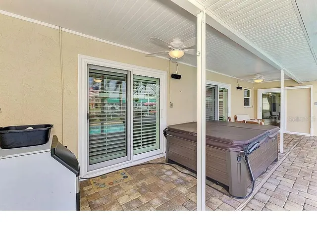a backyard of a house with a garden and barbeque oven