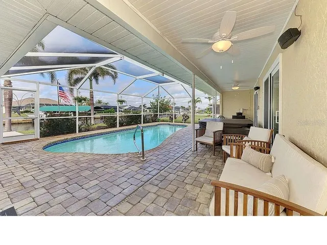 a backyard of a house with barbeque oven and a table and chairs