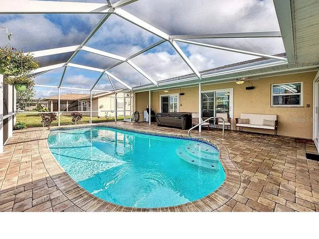 an aerial view of a house with a garden and lake view