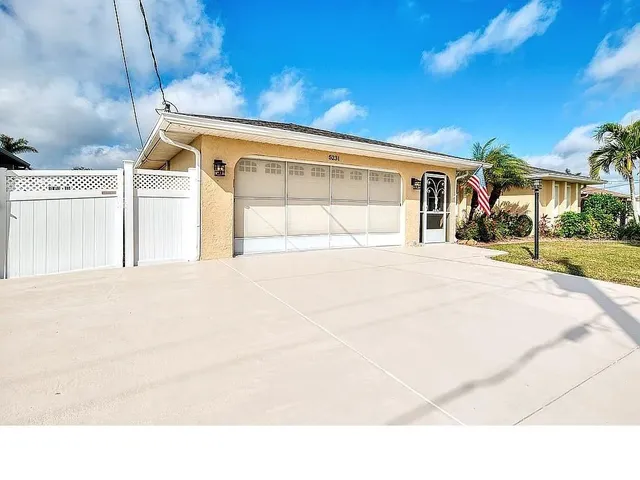 a living room with stainless steel appliances kitchen island granite countertop a couch and cabinets