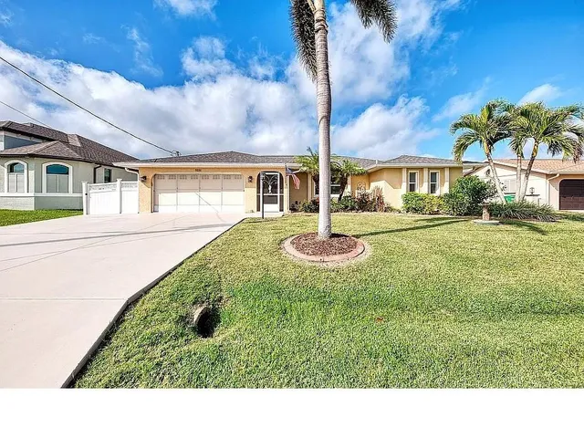 a open kitchen with stainless steel appliances granite countertop a refrigerator a stove top oven a sink and dishwasher