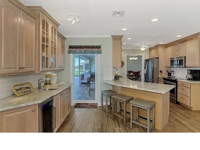 a kitchen with stainless steel appliances granite countertop a sink dishwasher stove and oven with cabinets