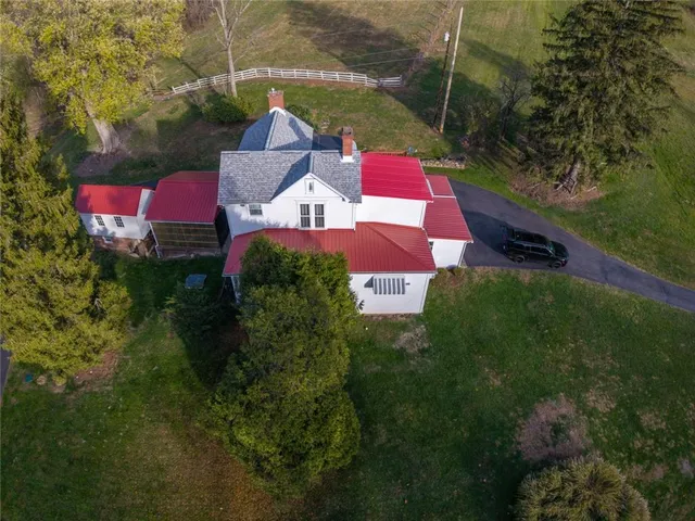 a bird view of a house with a yard