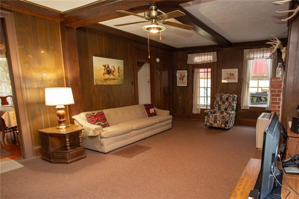 195 West W Railroad Road Sycamore, PA 15364 - Photo 25 of 50 a living room with furniture a chandelier and a flat screen tv