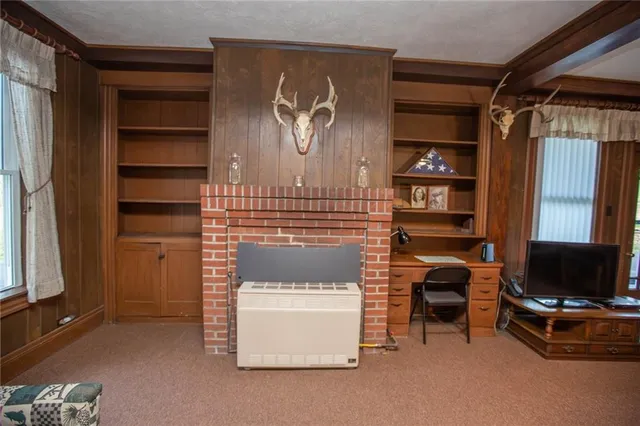 a kitchen with stainless steel appliances a refrigerator a stove a sink dishwasher and wooden cabinets with wooden floor