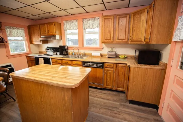 a bathroom with a granite countertop sink a window and shower