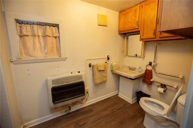 a bedroom with a bed and a flat tv screen on wall