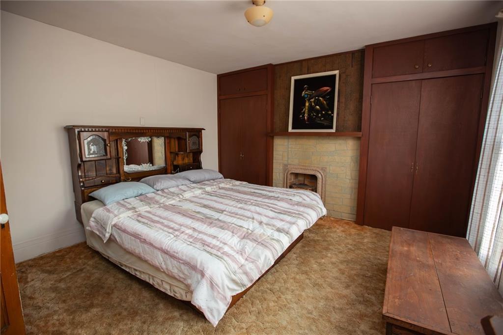 195 West W Railroad Road Sycamore, PA 15364 - Photo 39 of 50 a bedroom with a bed and a painting on the wall