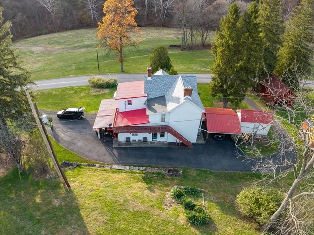 a view of a house with a patio and a yard