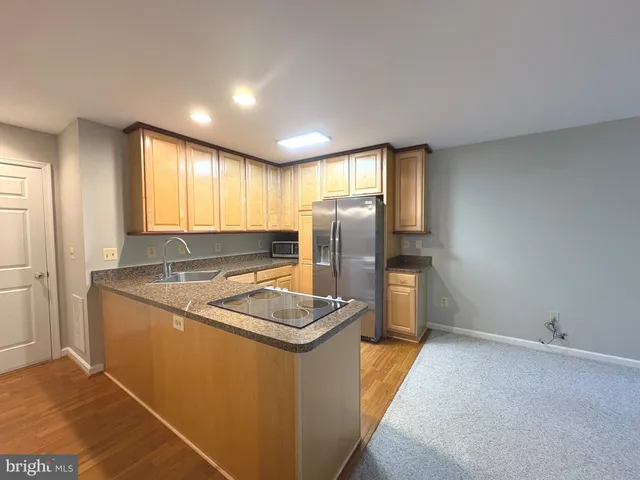a kitchen with a refrigerator and a sink