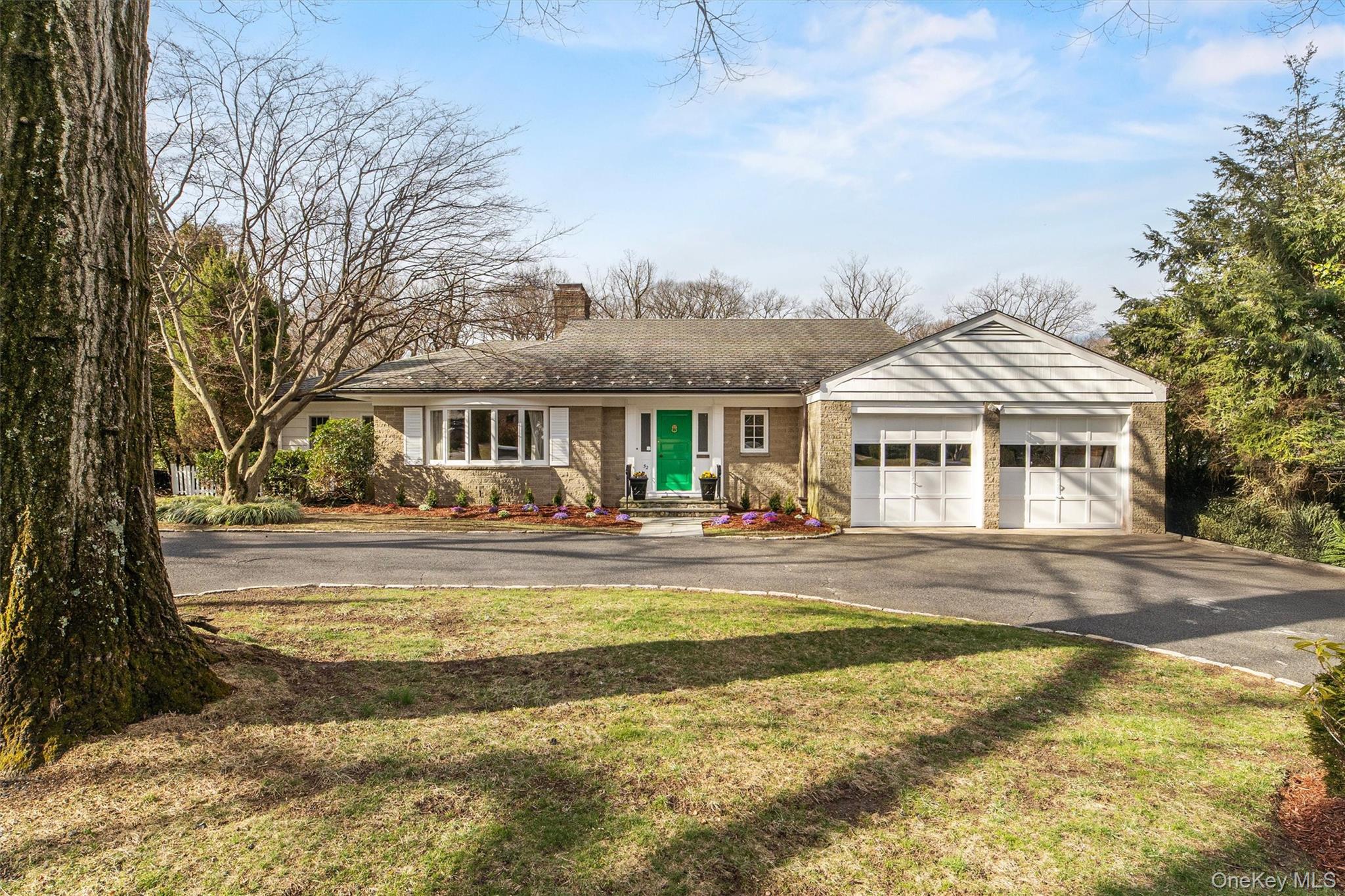 52 Oakledge Road Bronxville, NY 10708 - Photo 33 of 39 Ranch-style home featuring a front lawn, a chimney, a garage, and aphalt driveway
