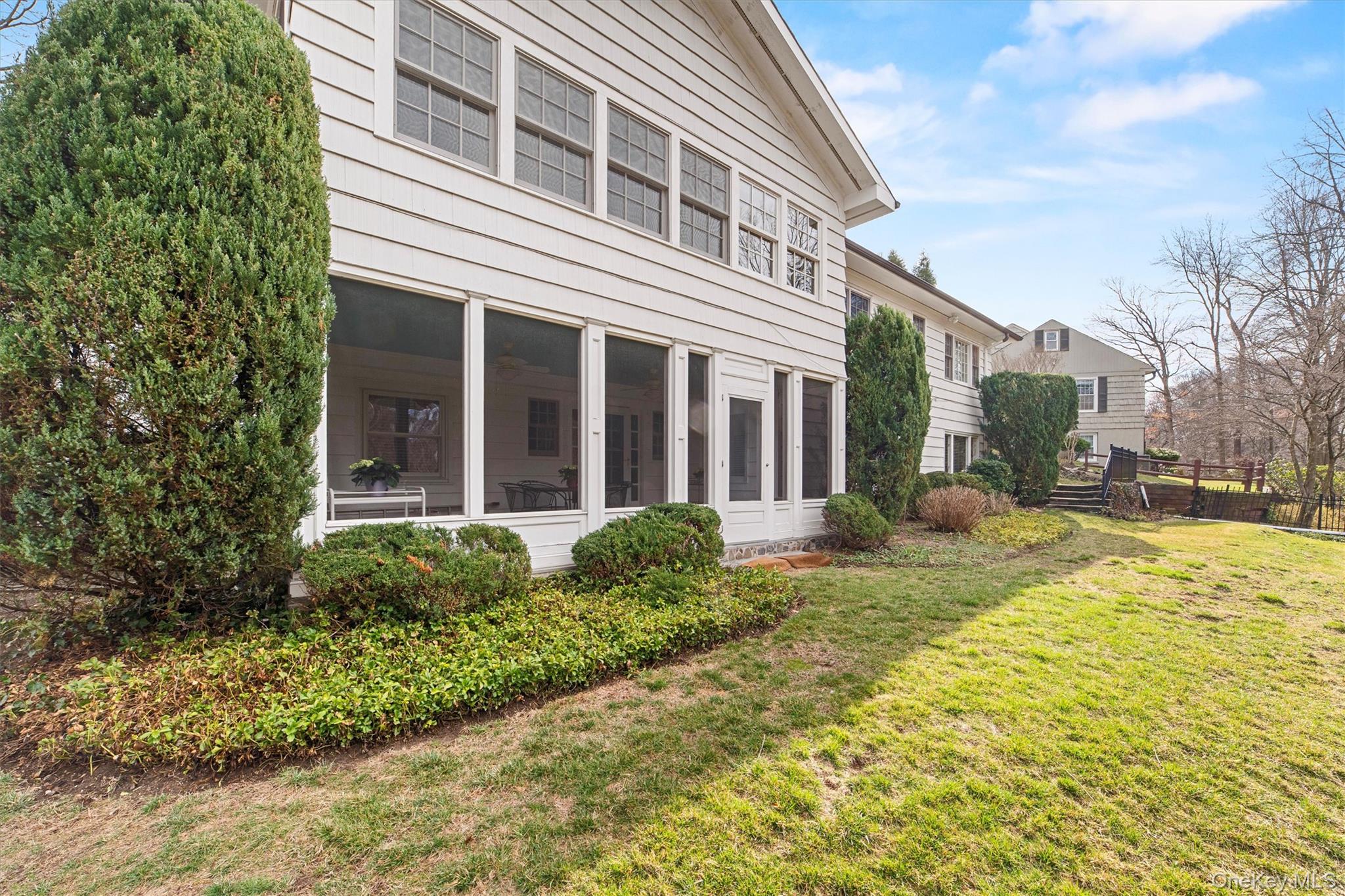 52 Oakledge Road Bronxville, NY 10708 - Photo 34 of 39 View of home's exterior featuring a lawn and a sunroom