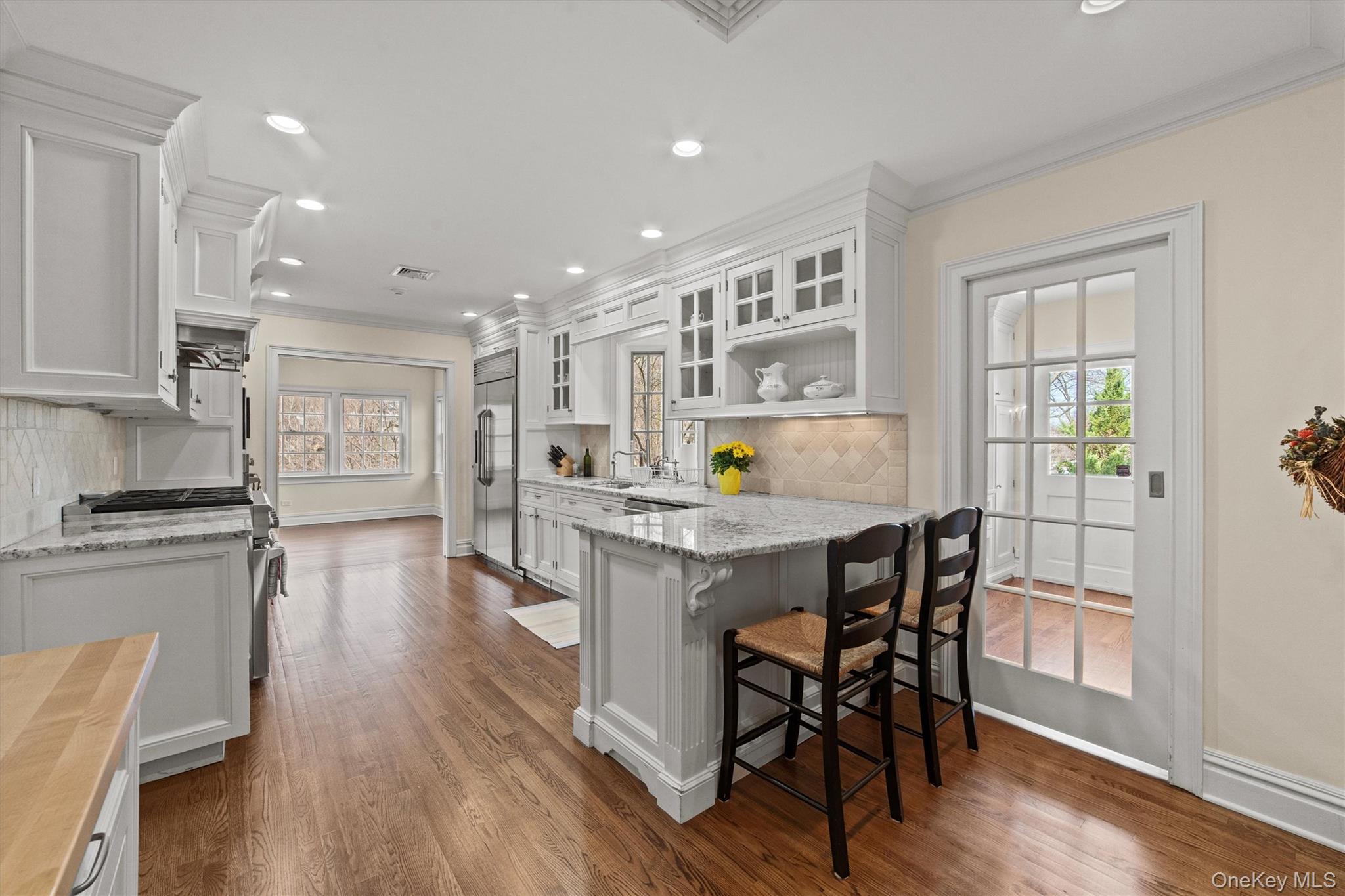 52 Oakledge Road Bronxville, NY 10708 - Photo 9 of 39 Kitchen featuring white cabinets, high quality appliances, crown molding, and dark wood-type flooring