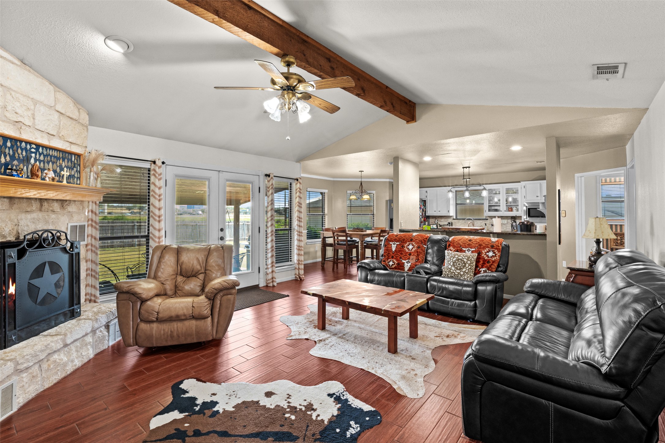 1512 Panther Loop Pflugerville, TX 78660 - Photo 22 of 40 A welcoming living area with rich wood flooring flows into an inviting kitchen and dining space.