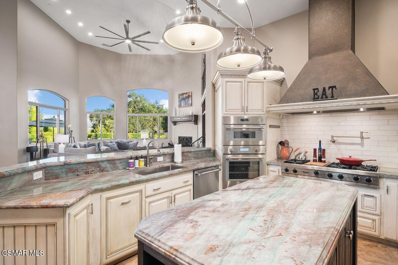 12490 MacDonald Drive Ojai, CA 93023 - Photo 21 of 87 a kitchen with stainless steel appliances a stove a sink and a refrigerator