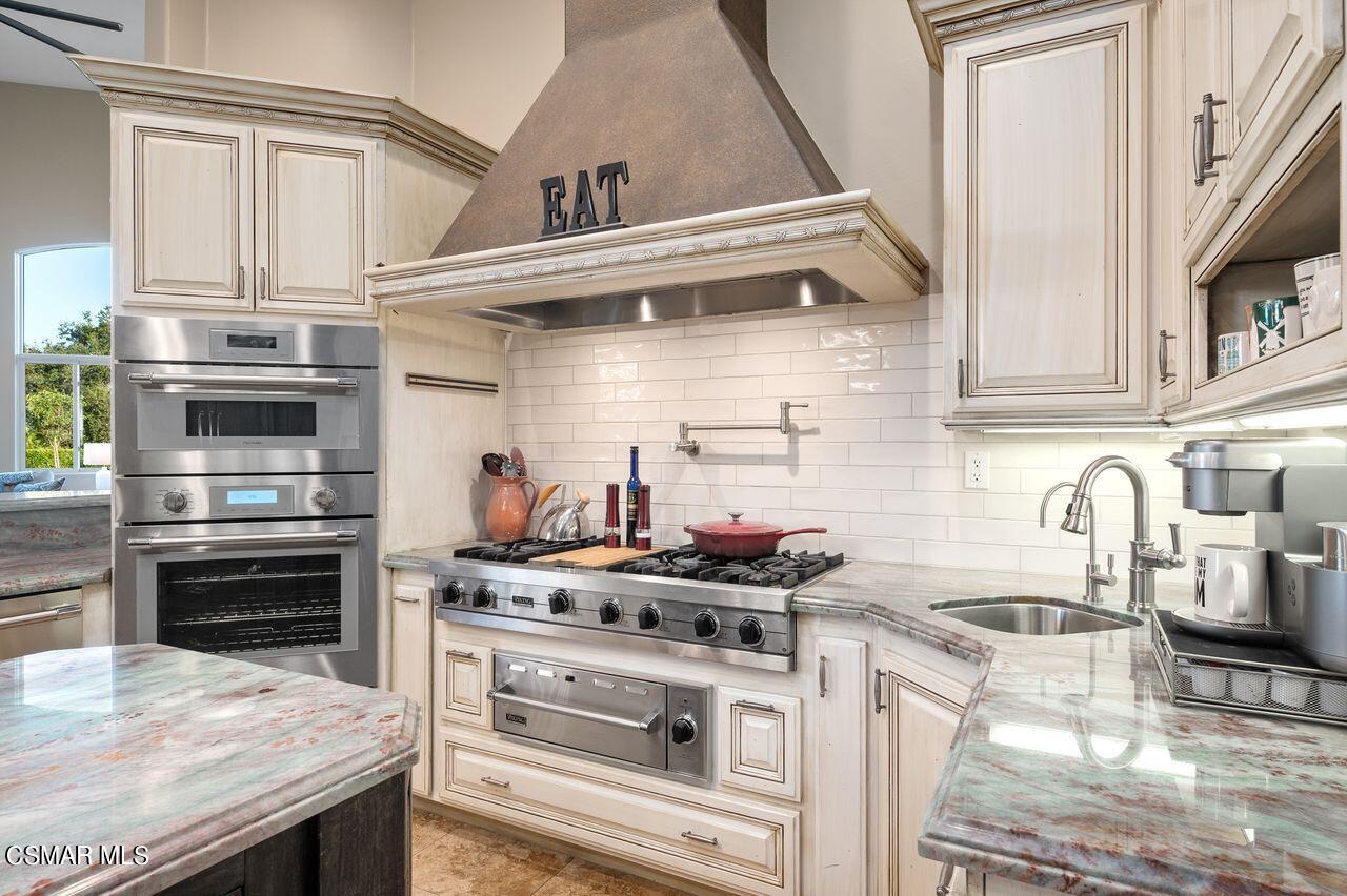 12490 MacDonald Drive Ojai, CA 93023 - Photo 22 of 87 a kitchen with stainless steel appliances granite countertop a stove and a sink